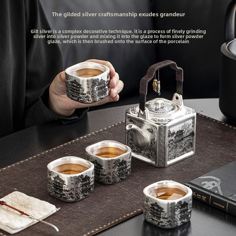 Master-crafted silver-plated Yueyang Tower Gongfu tea set (swing-handle pot and four cups)—premium home use and gift-ready.