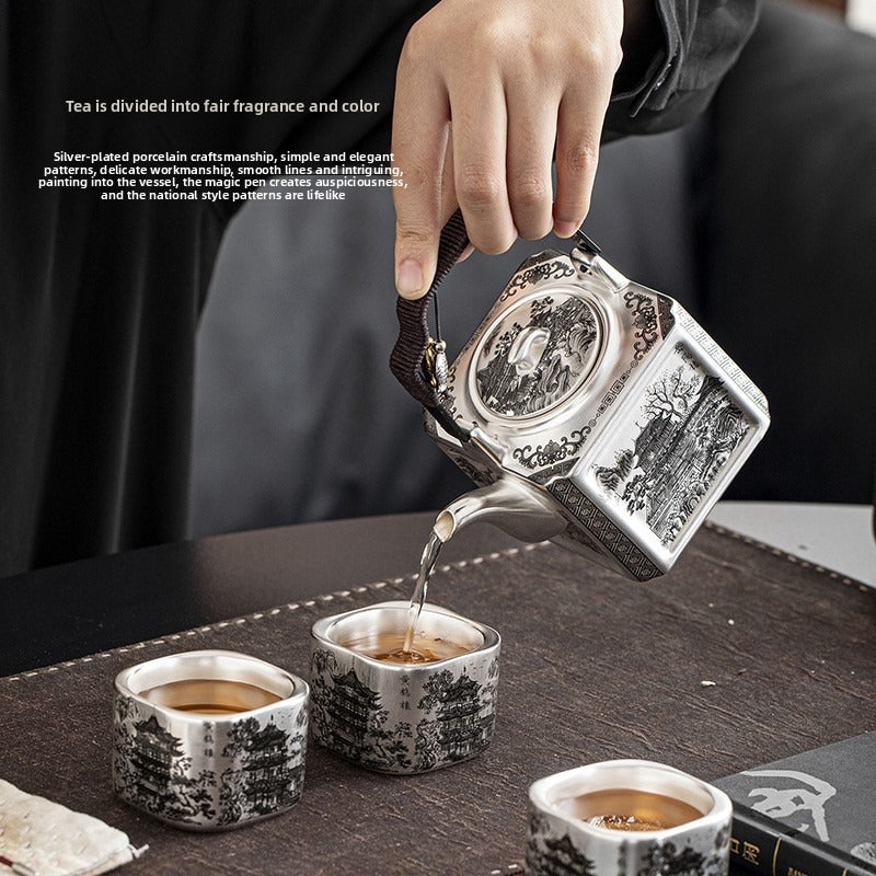Master-crafted silver-plated Yueyang Tower Gongfu tea set (swing-handle pot and four cups)—premium home use and gift-ready.
