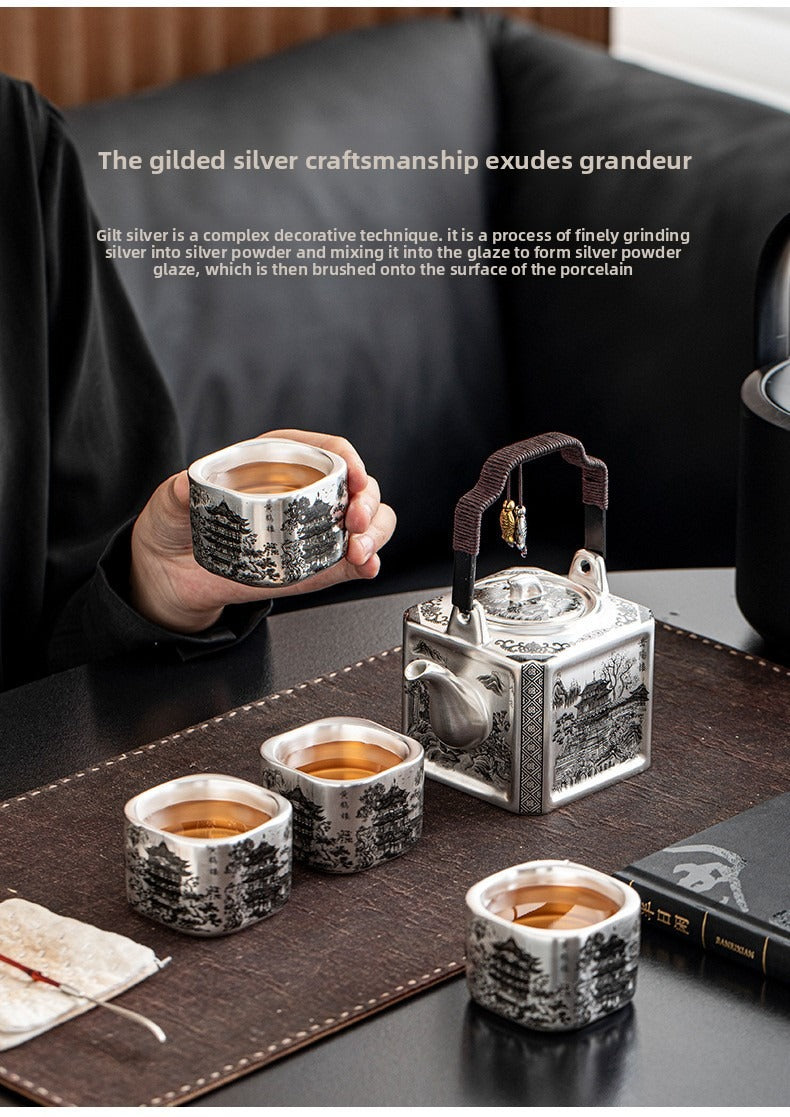 Master-crafted silver-plated Yueyang Tower Gongfu tea set (swing-handle pot and four cups)—premium home use and gift-ready.