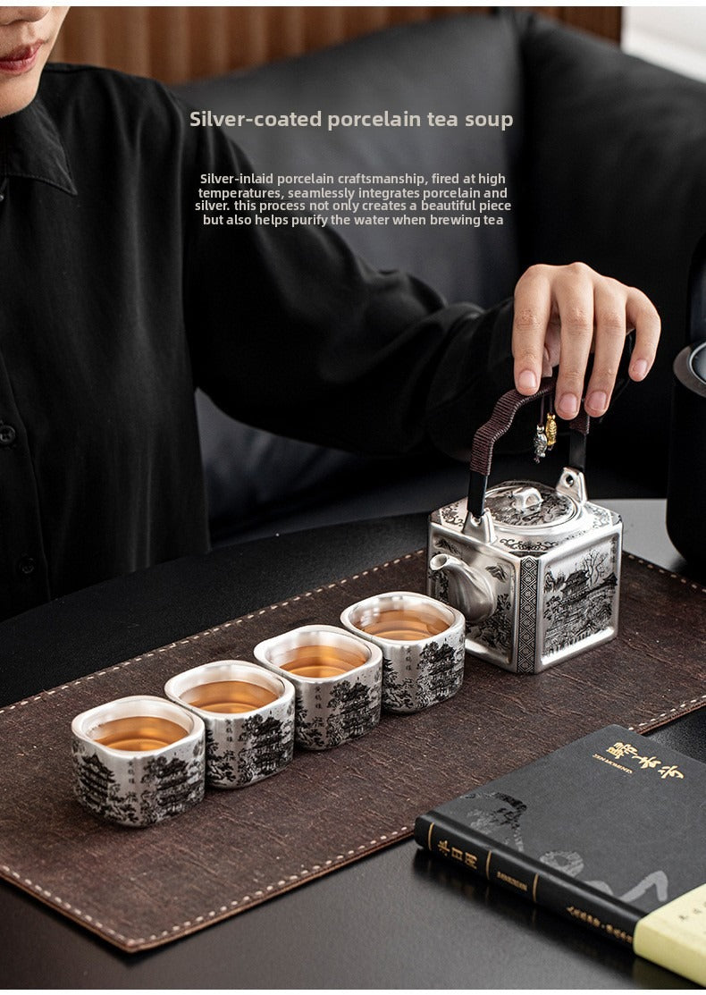 Master-crafted silver-plated Yueyang Tower Gongfu tea set (swing-handle pot and four cups)—premium home use and gift-ready.