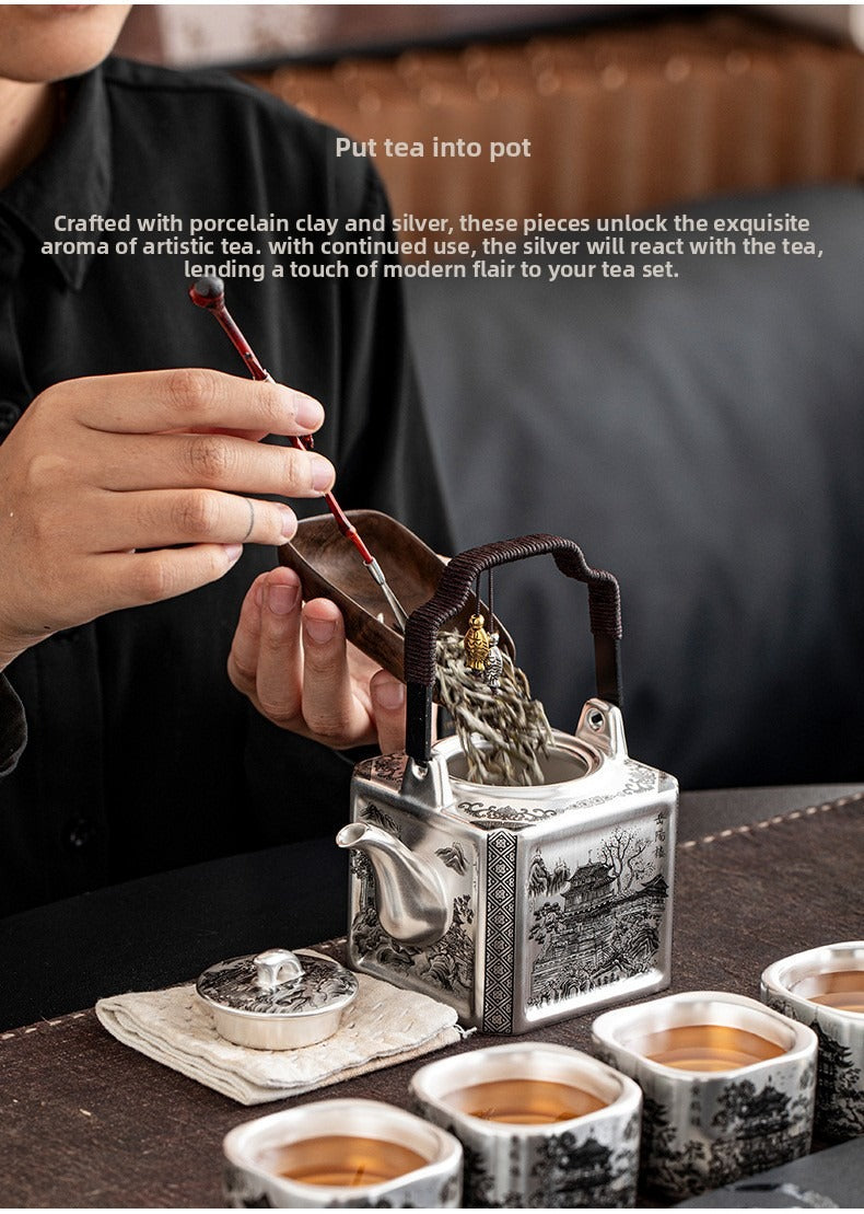 Master-crafted silver-plated Yueyang Tower Gongfu tea set (swing-handle pot and four cups)—premium home use and gift-ready.