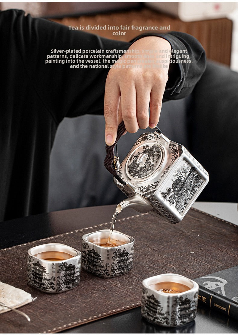 Master-crafted silver-plated Yueyang Tower Gongfu tea set (swing-handle pot and four cups)—premium home use and gift-ready.